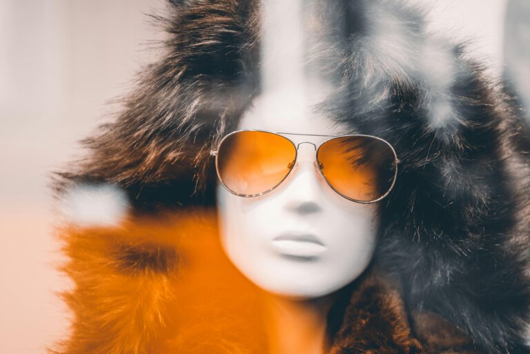 Mannequin wearing fur coat and sunglasses. Cruelty-free