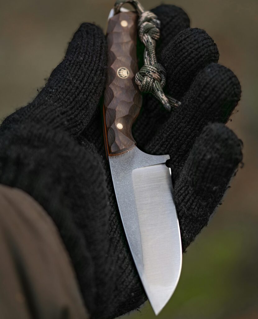 Person holding a knife with glove on. Survive, Survival